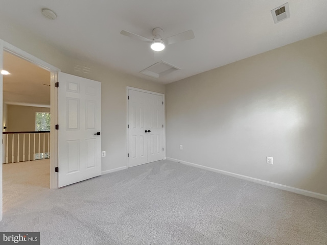 unfurnished bedroom with light colored carpet, a closet, and ceiling fan