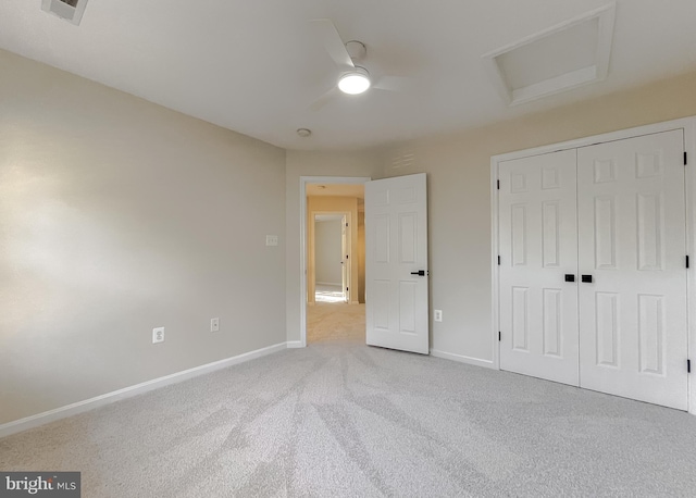 unfurnished bedroom with light carpet, a closet, and ceiling fan