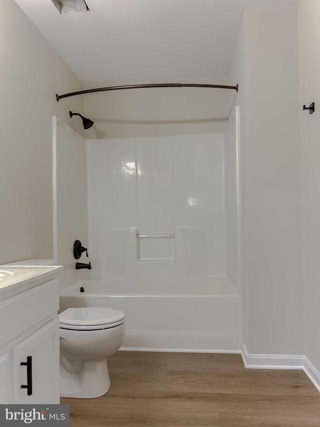 full bathroom featuring vanity, hardwood / wood-style floors, toilet, and bathing tub / shower combination