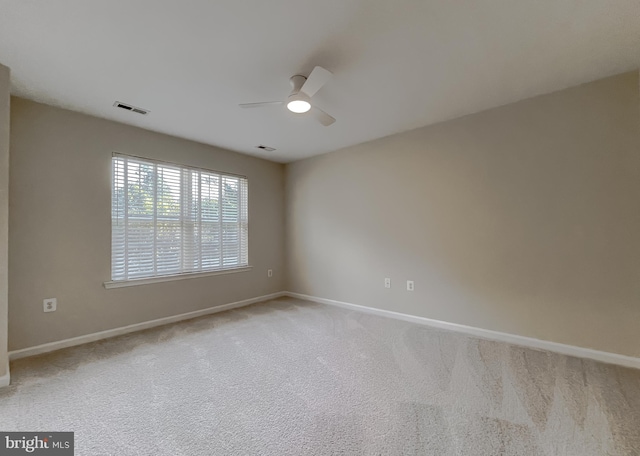 empty room featuring carpet flooring and ceiling fan