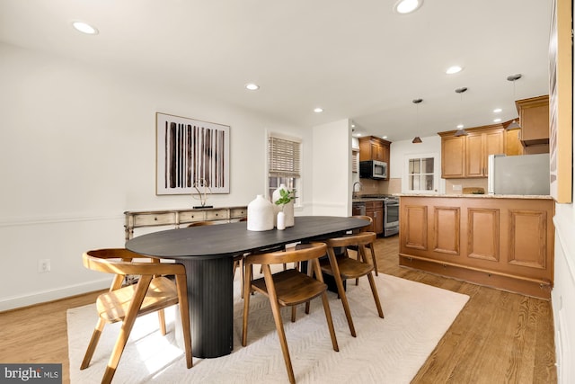 dining area with light hardwood / wood-style flooring