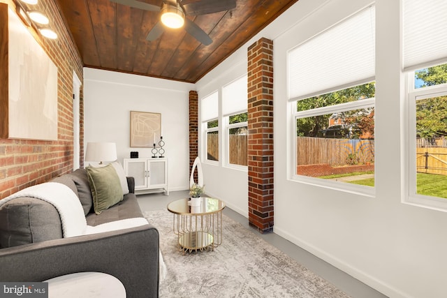 sunroom featuring wooden ceiling, plenty of natural light, and ceiling fan