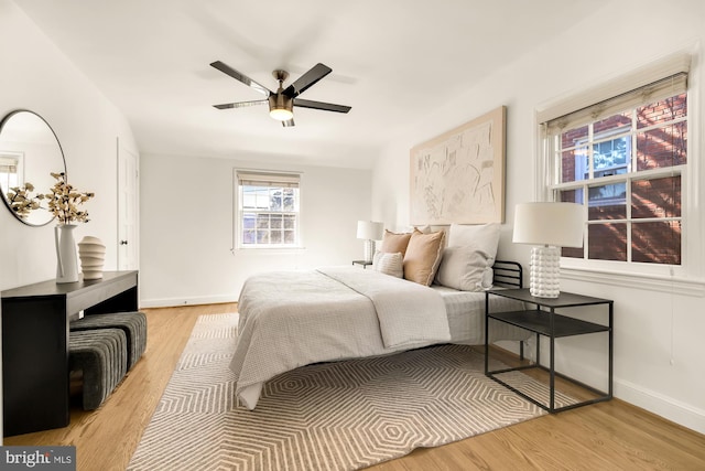 bedroom with light hardwood / wood-style floors and ceiling fan