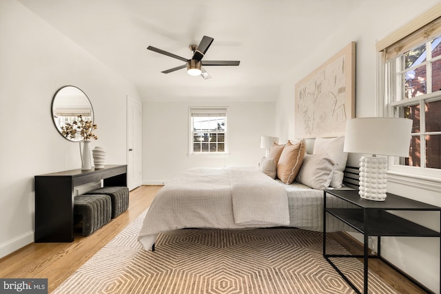 bedroom with ceiling fan and light wood-type flooring