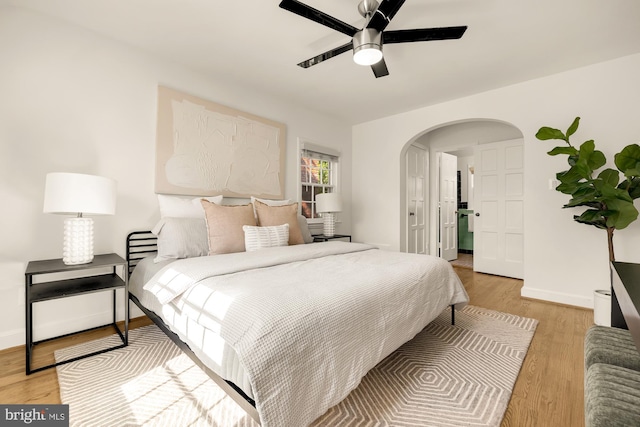 bedroom with light hardwood / wood-style floors and ceiling fan