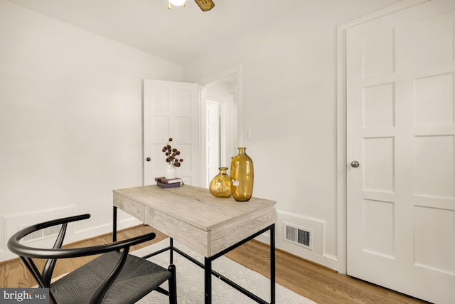 office with light hardwood / wood-style floors and ceiling fan