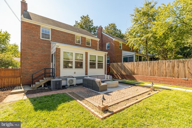 back of property with a patio, an outdoor living space, a yard, and central air condition unit