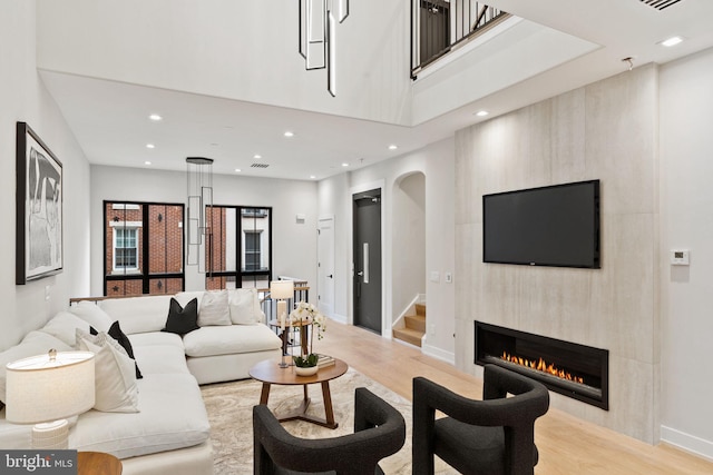 living room featuring a fireplace and light hardwood / wood-style floors