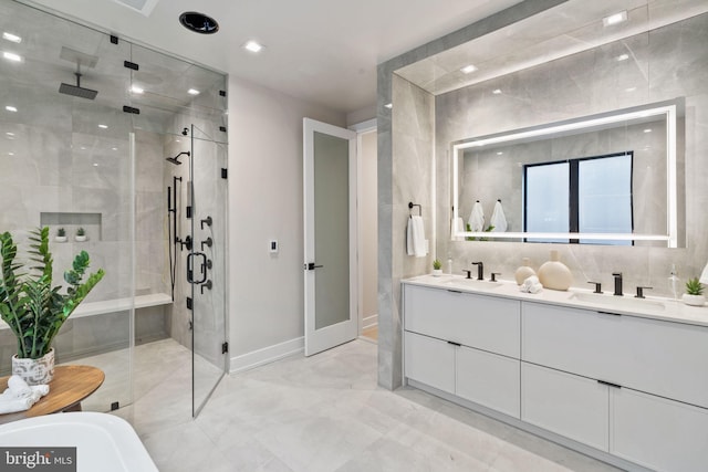 bathroom with a shower with shower door and vanity