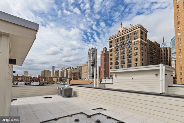 view of patio featuring central air condition unit and a balcony