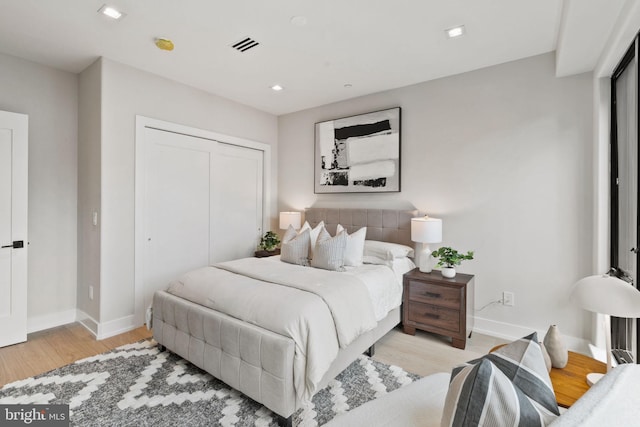 bedroom with a closet and light hardwood / wood-style floors