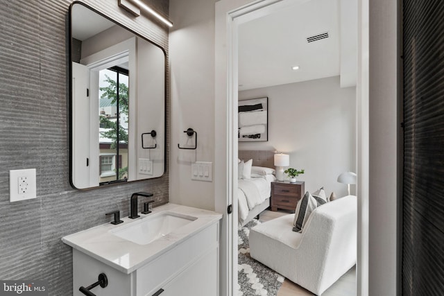 bathroom with tile walls and vanity