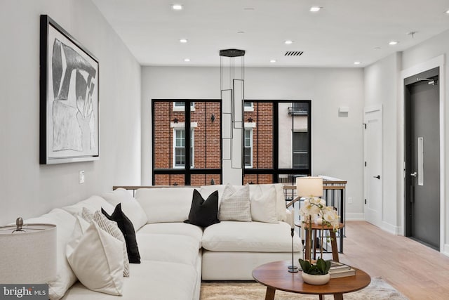 living room with light hardwood / wood-style flooring