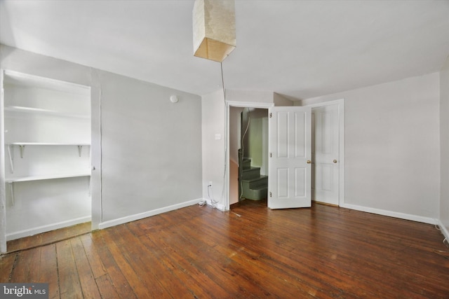 unfurnished bedroom with dark hardwood / wood-style floors