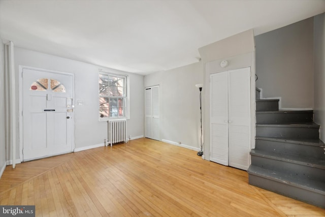 foyer featuring light hardwood / wood-style flooring and radiator