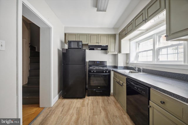 kitchen with black appliances, sink, and light wood-type flooring