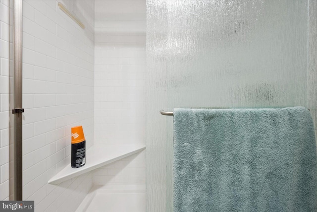 bathroom with tiled shower