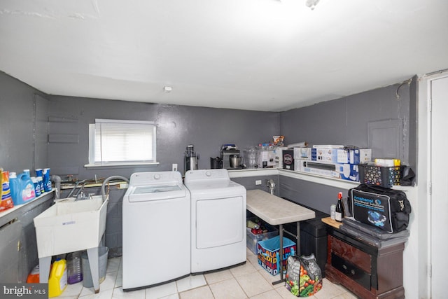 laundry room with sink, light tile patterned floors, and washing machine and clothes dryer