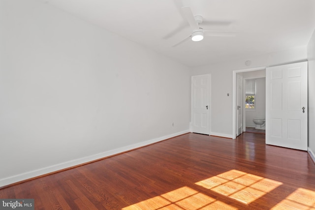 spare room with dark wood-type flooring and ceiling fan