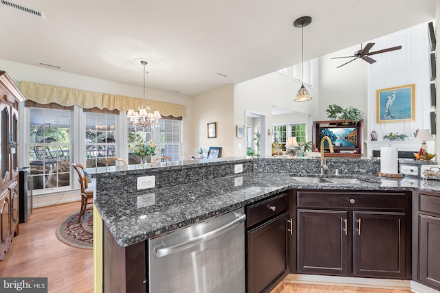 kitchen featuring a wealth of natural light, light hardwood / wood-style floors, sink, and stainless steel dishwasher