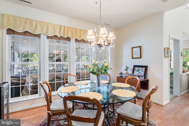 dining space featuring a notable chandelier and wood-type flooring