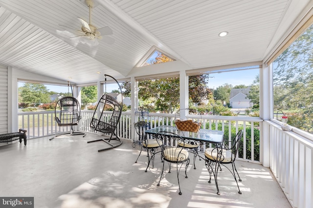 sunroom with a healthy amount of sunlight, ceiling fan, and vaulted ceiling