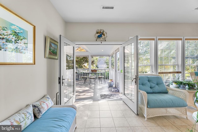 doorway featuring light tile patterned flooring, plenty of natural light, and french doors