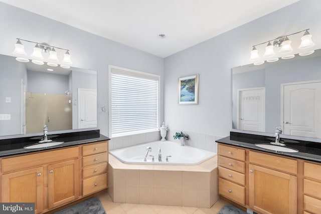 bathroom featuring tile patterned flooring, vanity, and independent shower and bath