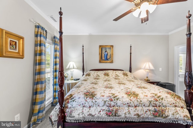 carpeted bedroom with ornamental molding and ceiling fan