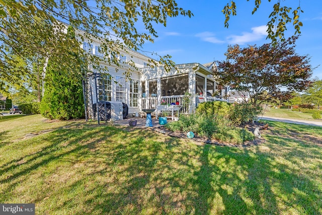 rear view of property featuring a yard