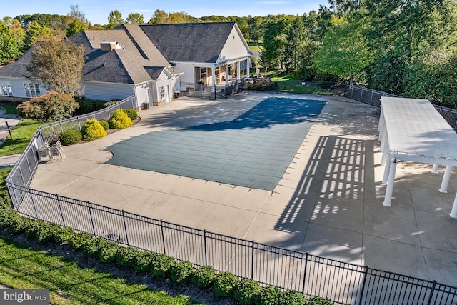 view of pool with a wooden deck and a patio