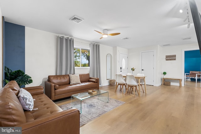 living room featuring ceiling fan and light hardwood / wood-style flooring