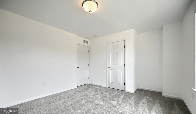 unfurnished bedroom featuring light carpet and a closet