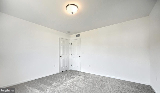 unfurnished room featuring carpet