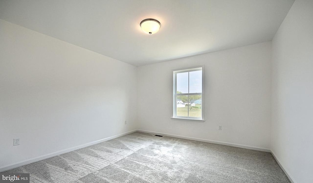 spare room with light colored carpet