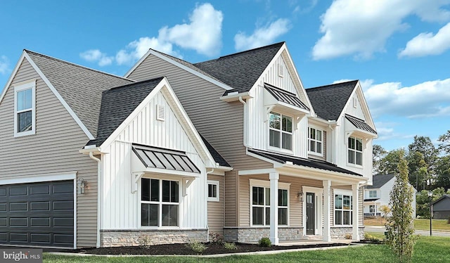 view of front of property featuring a garage and a front lawn