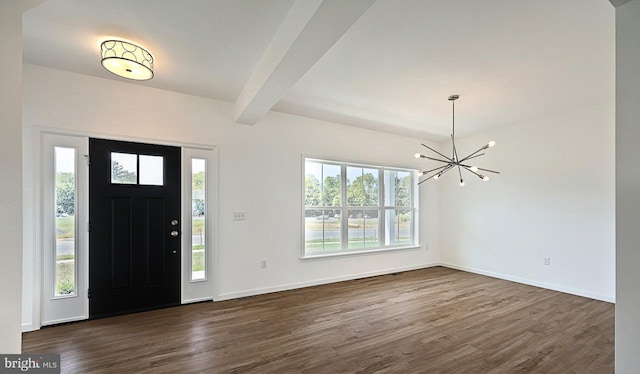 foyer with a healthy amount of sunlight, dark wood-type flooring, and beamed ceiling