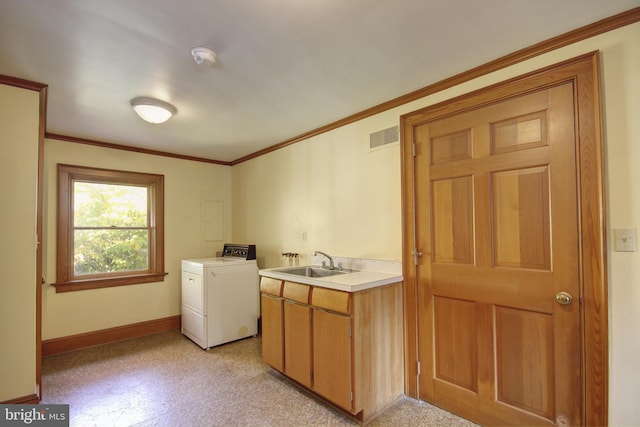 laundry room with crown molding, washer / clothes dryer, sink, and cabinets