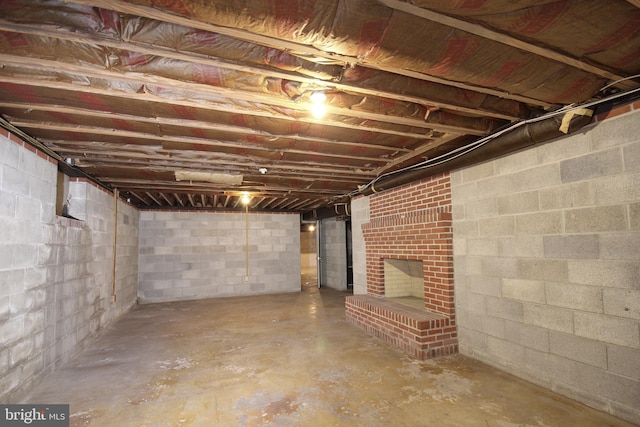 basement with a brick fireplace