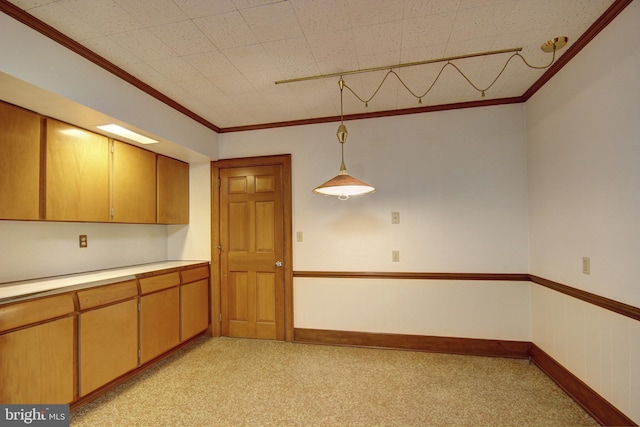 kitchen featuring crown molding, light colored carpet, and pendant lighting