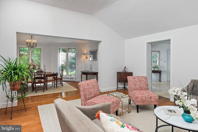 living room featuring lofted ceiling, hardwood / wood-style floors, a baseboard heating unit, and a notable chandelier