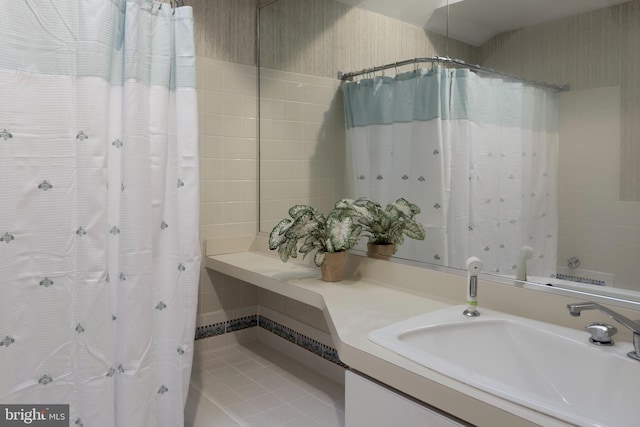 bathroom featuring vanity and curtained shower