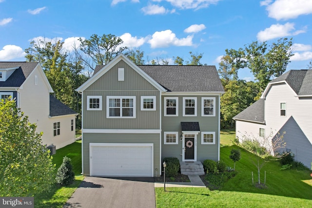 view of front of property featuring a front lawn and a garage