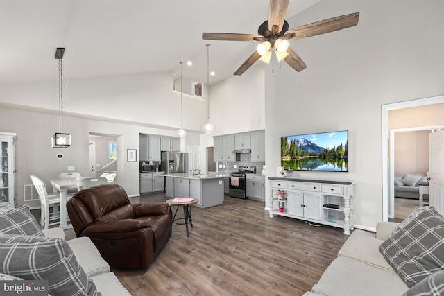 living room with dark wood-type flooring, high vaulted ceiling, and ceiling fan