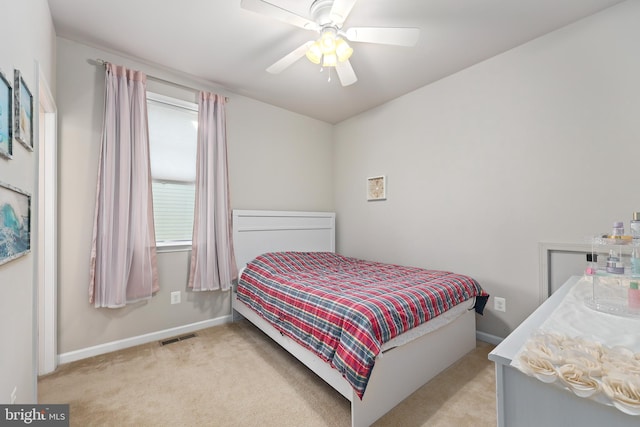 bedroom with ceiling fan and light carpet