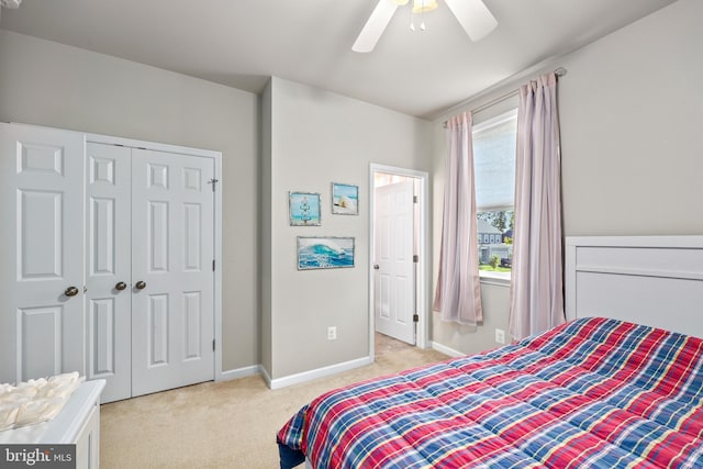 carpeted bedroom featuring a closet and ceiling fan