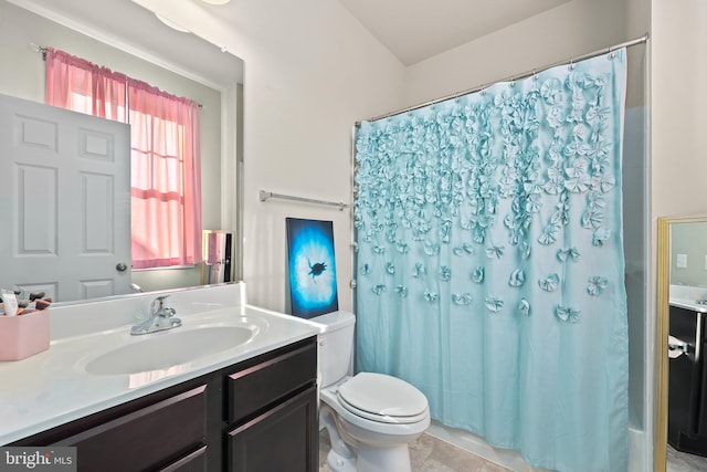 bathroom featuring vanity, a shower with shower curtain, toilet, and tile patterned floors