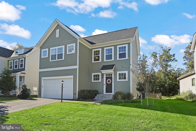 view of front of home with a front yard and a garage