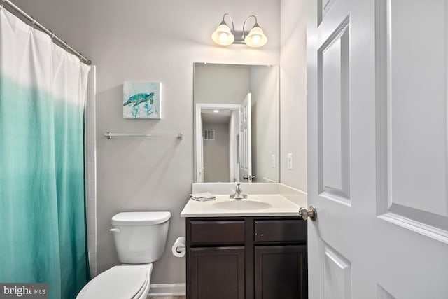 bathroom featuring toilet and vanity