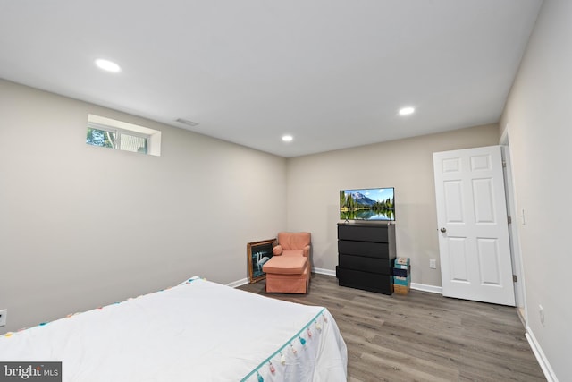 bedroom with dark hardwood / wood-style flooring